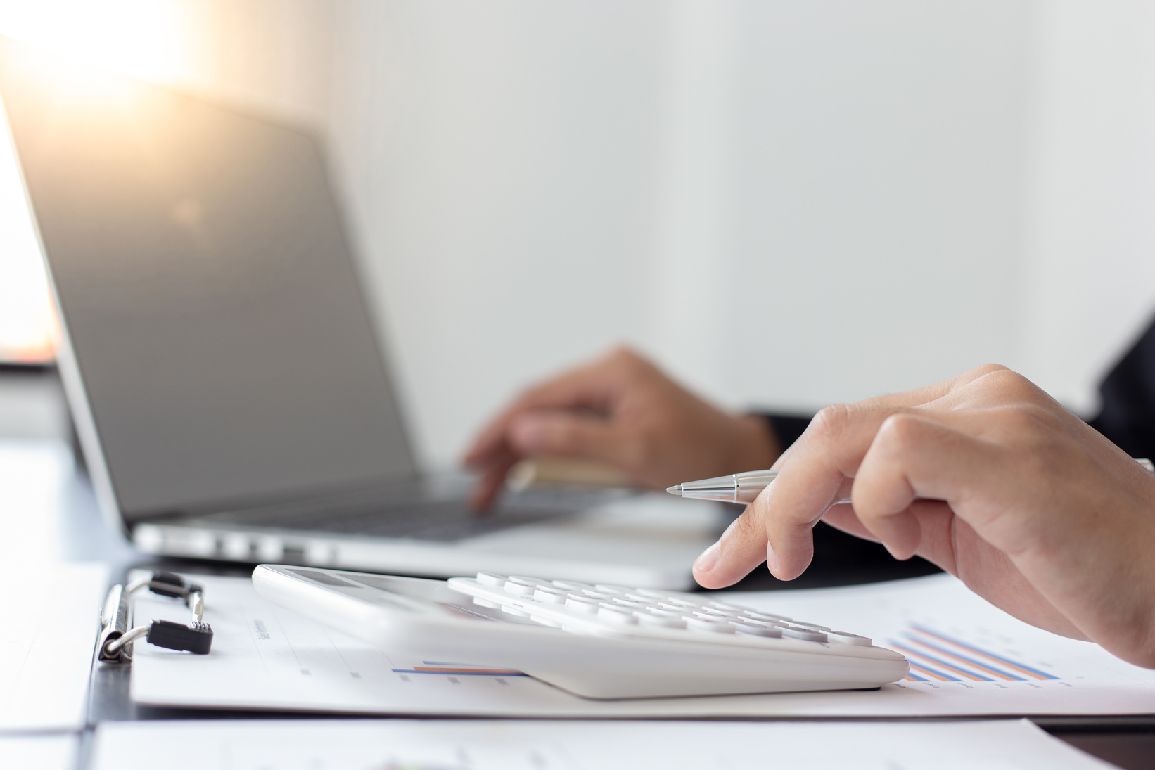 Businesswoman Using a Laptop and Calculator